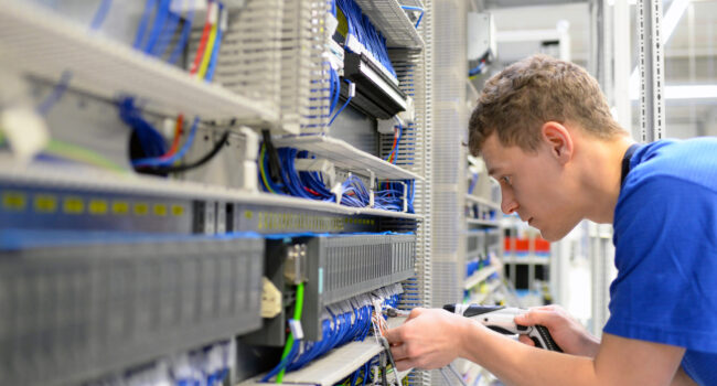 Young,Apprentice,Worker,In,An,Industrial,Company,Assembling,Electronic,Components